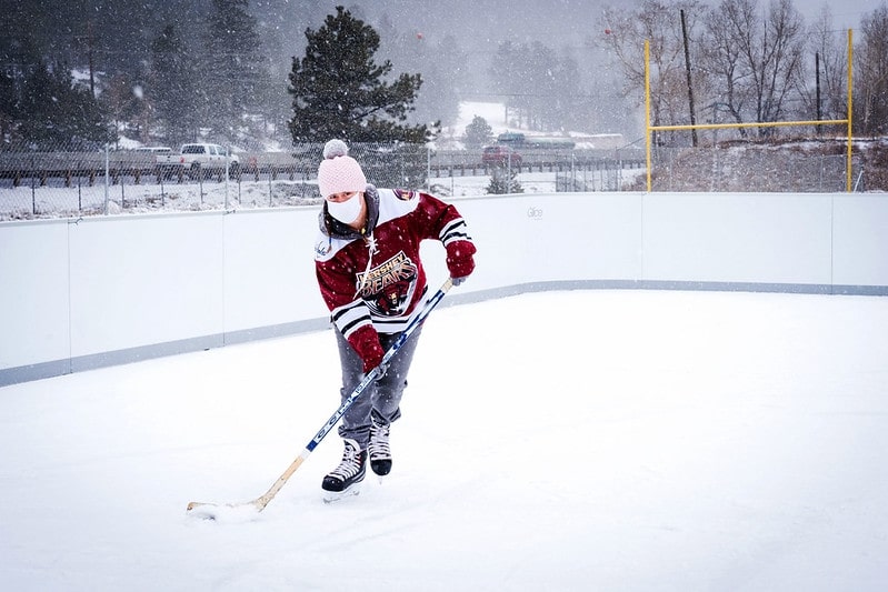 Boy skating in snowed in rink