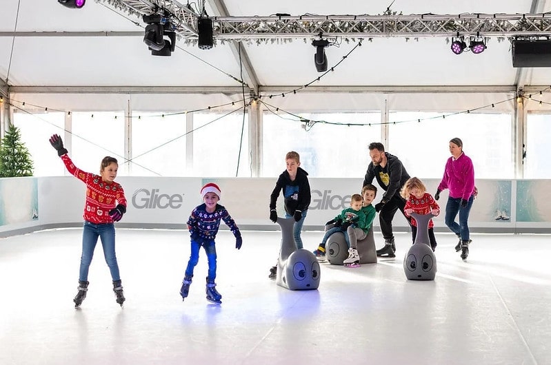 Family skating on synthetic ice