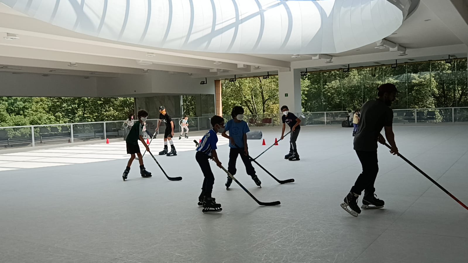 kids learning to play ice hockey on synthetic ice